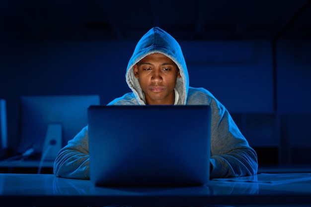 Black man hoodie or hacker with laptop for cybersecurity problem malware or phishing for crime Programmer night and software update on technology with dark hacking expert writing algorithm system