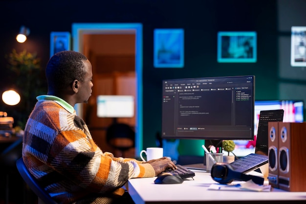 black software engineer writes complex binary code scripts on computer