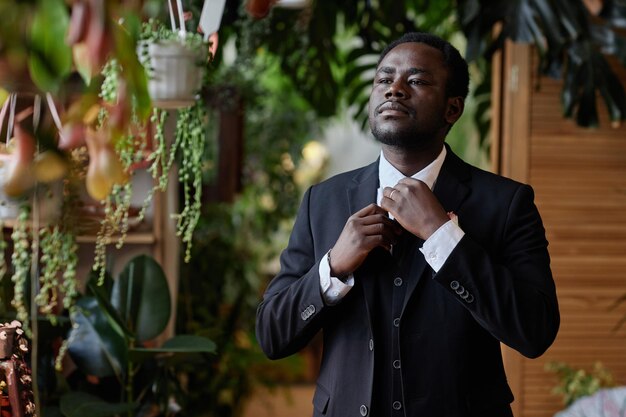 black young man as anxious groom waiting for bride at altar