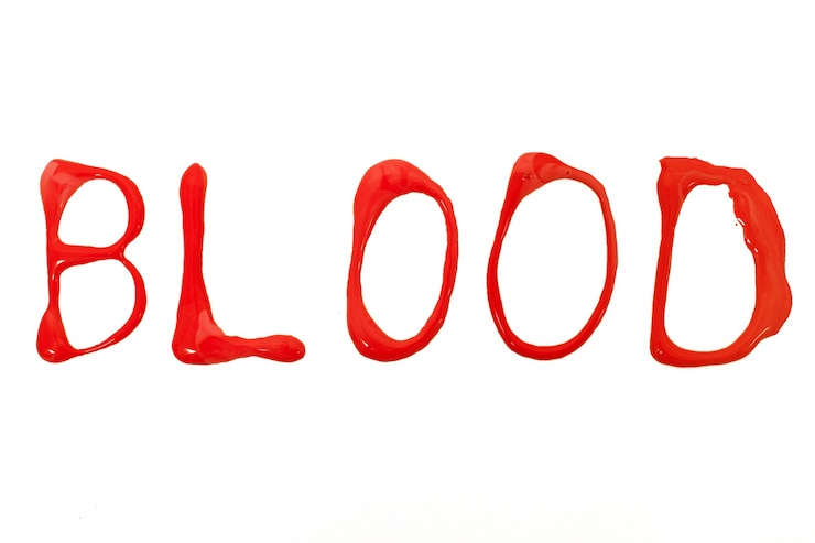 Photo blood stain drops letters isolated on a white background.