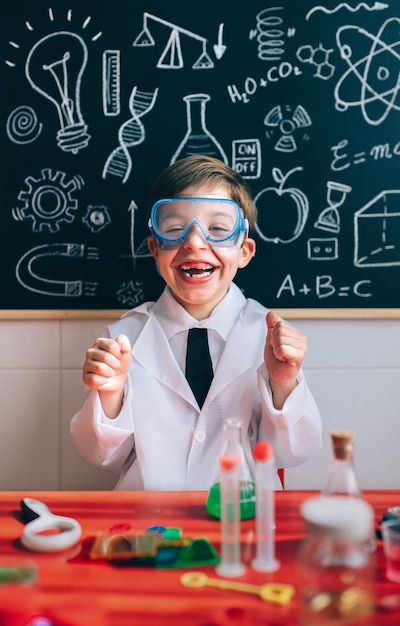 Boy wearing lap coat while sitting in classroom