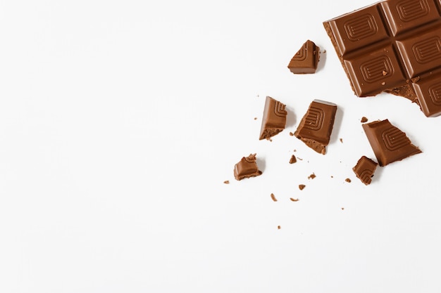 Broken chocolate bar on white background