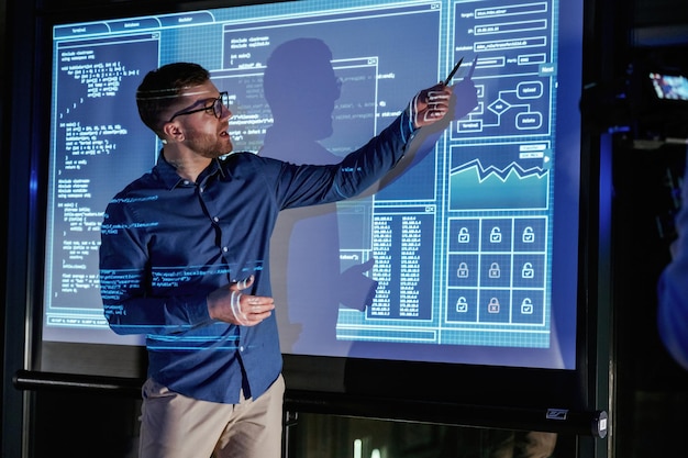 Business coach against projector with data