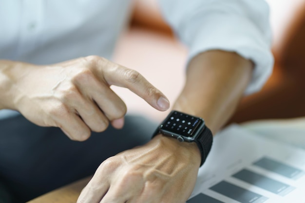 Business man Looking at smart watch In Office online connect Gadget technology