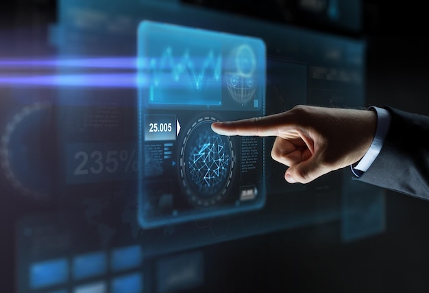 business, people and technology concept - close up of businessman hand pointing finger to virtual screen projection over black background