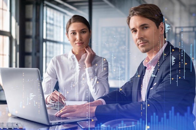 Businessman and businesswoman in formal wear working together to optimize trading strategy at corporate finance fund Forex chart hologram over office background with panoramic windows