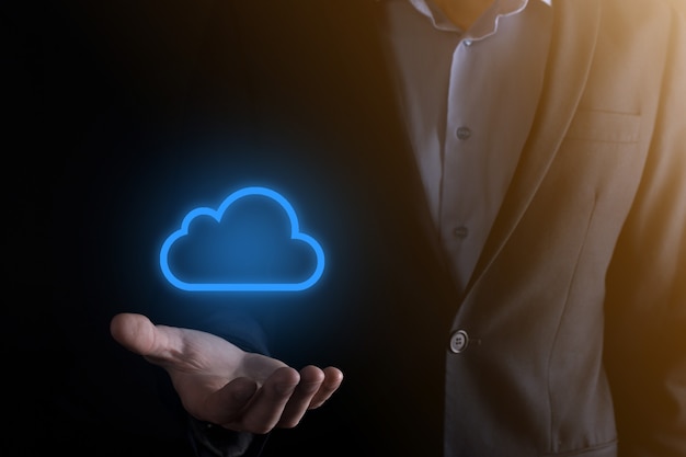 Businessman hand holding cloud computing concept in palm.