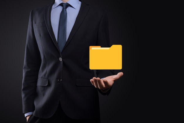 Businessman hold folder icon.Document Management System or DMS setup by IT consultant with modern computer are searching managing information and corporate files.Business processing,