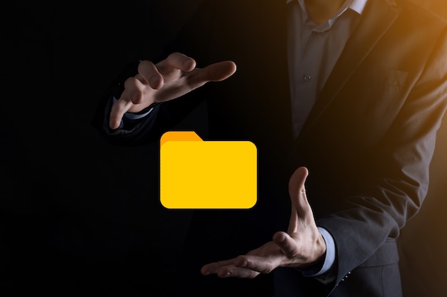Businessman hold folder icon.Document Management System or DMS setup by IT consultant with modern computer are searching managing information and corporate files.Business processing,