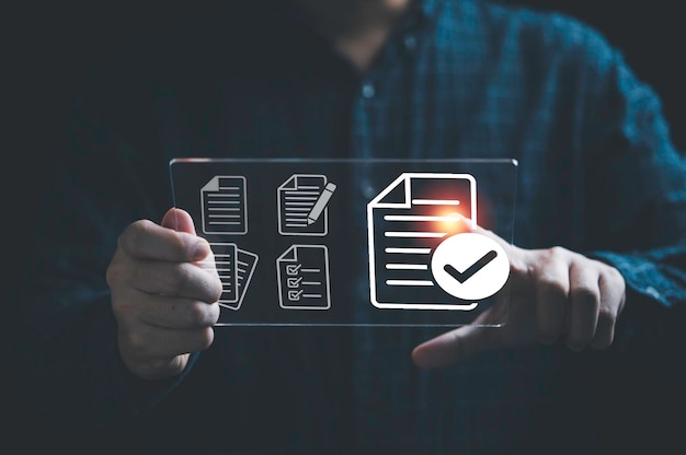 Businessman holding virtual tablet with virtual document and correct mark sign for online paperless approve project document and quality assurance concept