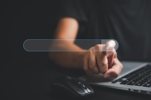 businessman's hand touches the button of a blank search bar on a business web banner