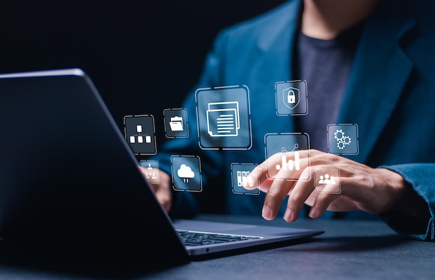 Businessman use laptop with virtual document management system for online document database and automated processes in file management Search and manage document database files online