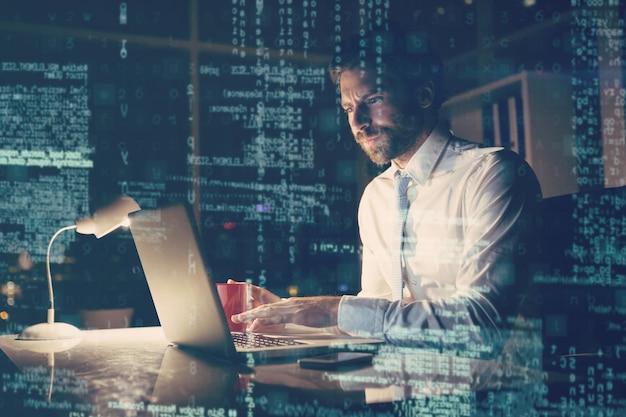 Businessman using laptop at night