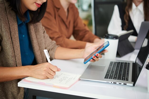 Businesswoman making notes in her notepad