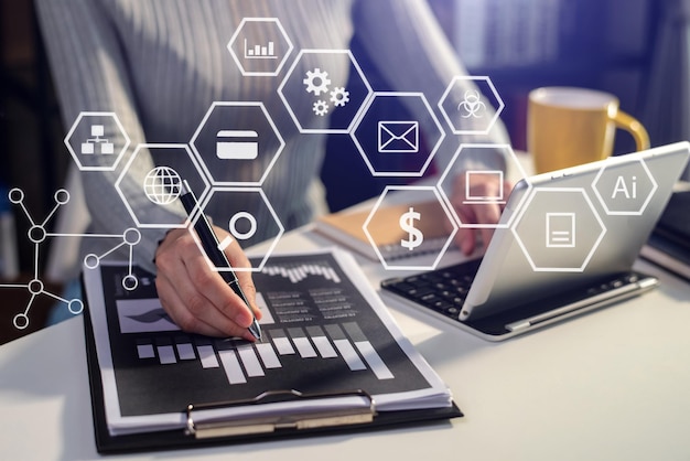 businesswoman or designer using mobile phone with laptop and digital tablet laptop and document on desk in office with virtual icons network diagram in morning lightxa