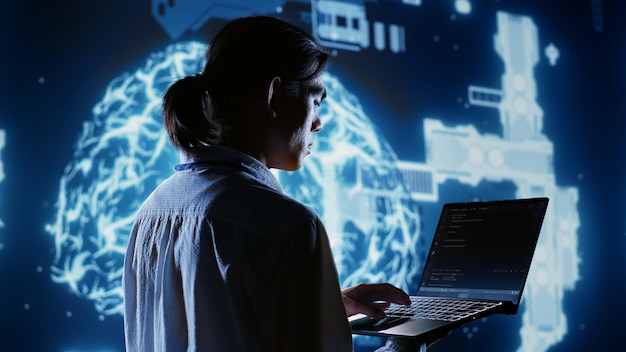 Certified admin writing artificial intelligence script code in startup workspace on laptop terminal Knowledgeable expert doing maintenance work in high tech facility updating AI systems
