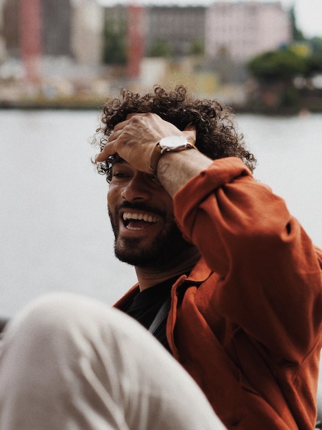 cheerful young man looking away outdoors