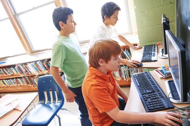 children education or kids in classroom with computer for learning research or website search scholarship thinking or students happy in school library for social network academy or assessment