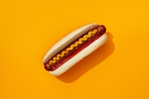 classic hot dog with wurst ketchup and mustard on orange background restaurant menu