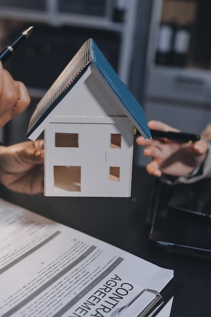 Close up Business people or Real Estate agent explain signing agreement for sale house to client Property Insurance Broker concept