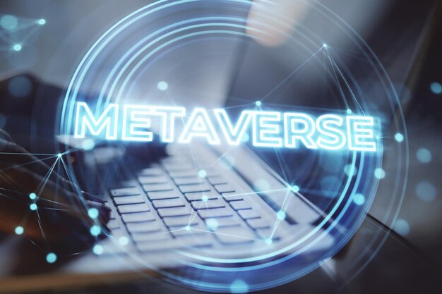 Close up of backlit female hands using laptop on desktop with creative glowing metaverse background Virtual reality and world concept Double exposure
