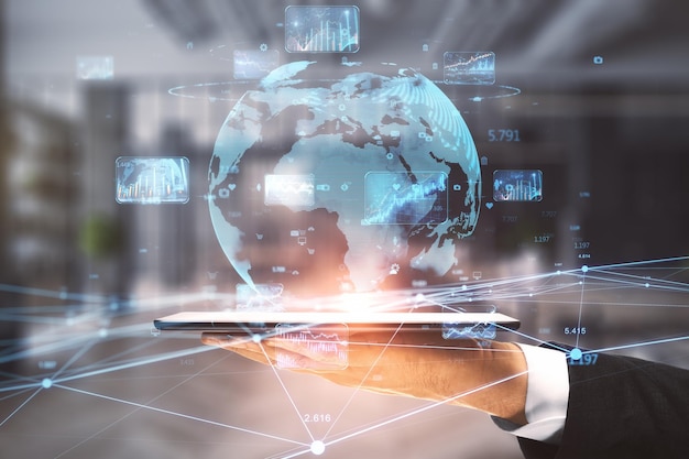 Close up of businessman hand holding digital pad with creative glowing globe hologram