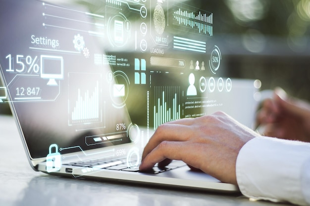 close up of businessman hand using laptop keyboard on desktop with coffee cup