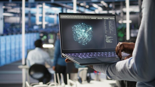 Close up of data center admin using machine learning algorithms on laptop to analyze large datasets