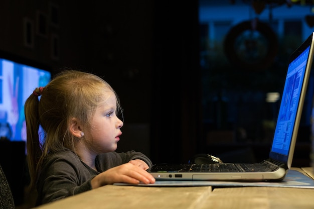 Close-up of girl using laptop at night