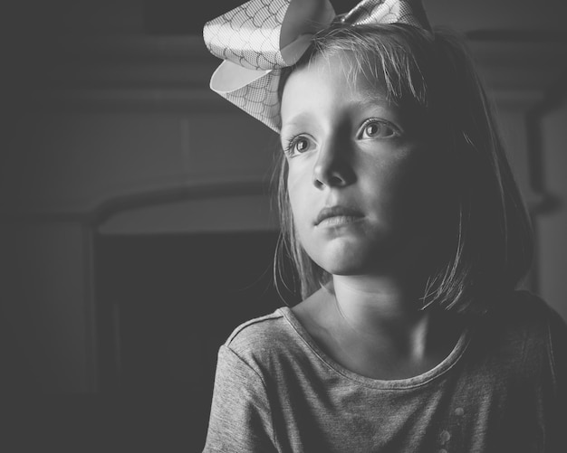 close-up of girl wearing hair bow at home