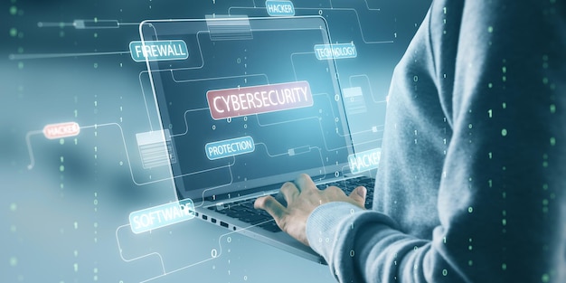 Close up of hacker hands using laptop with glowing hacking hologram with binary code and lines Cybersecurity firewall technology and software protection concept Double exposure