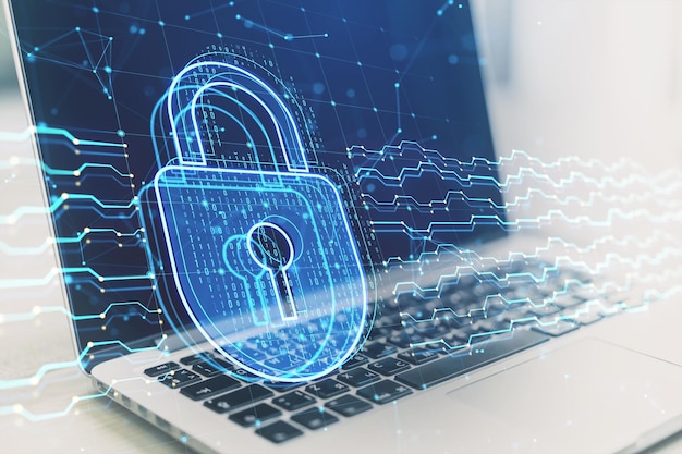 close up of laptop computer with glowing digital padlock hologram on blurry background safety and security concept double exposure