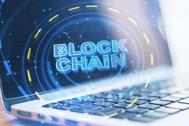 close up of laptop on notebook with abstract blockchain interface cryptocurrency and technology concept double exposure