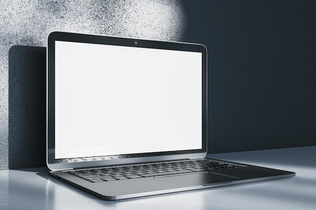 Close up of notebook computer with empty white mock up screen placed on desk Concrete wall with shadows in the background 3D Rendering