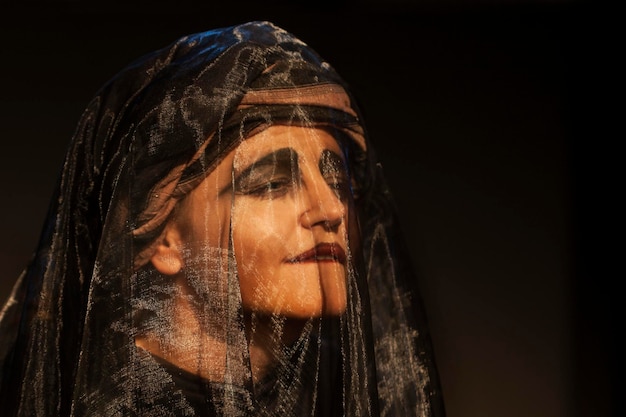 close-up of performer wearing veil in theater