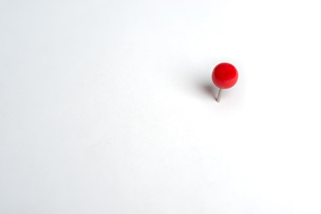 Close-up of push pin over white background
