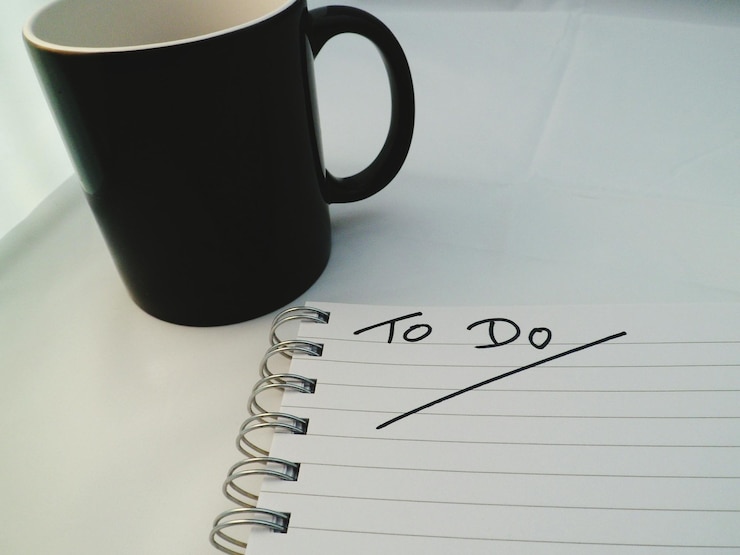 Photo close-up of text and mug on table to do list