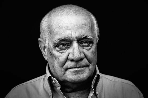 close-up of thoughtful man against black background