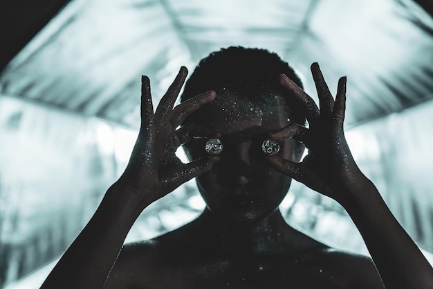 close-up of woman covered in glitter holding diamonds