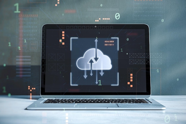 Close up of workplace desktop with laptop computer and digital cloud computing hologram on blurry background Cloud data server service and hosting concept Double exposure