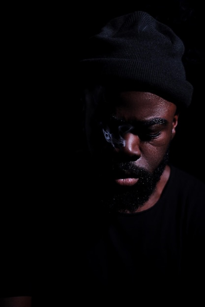 close-up of young man against black background