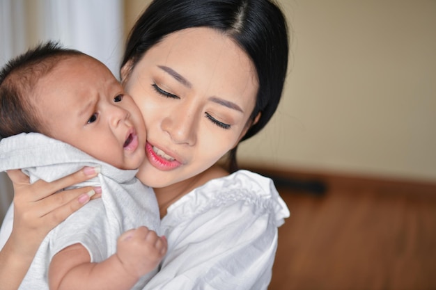 close-up of young woman carrying baby boy