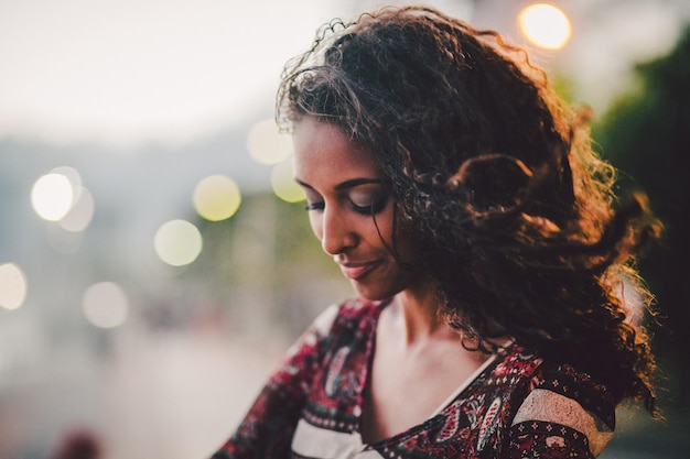 close-up of young woman smiling during sunset