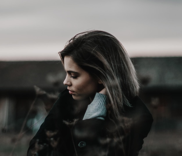 close-up of young woman standing against sky