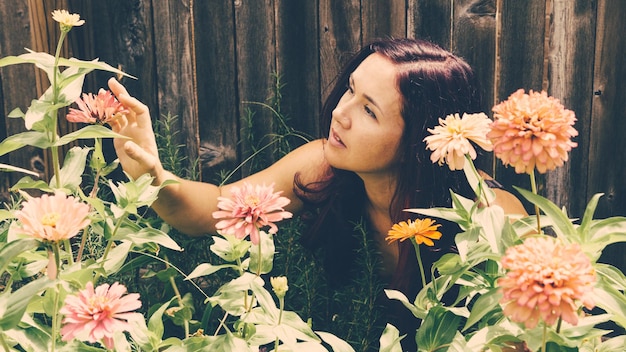 close-up of young woman with flowers and plants