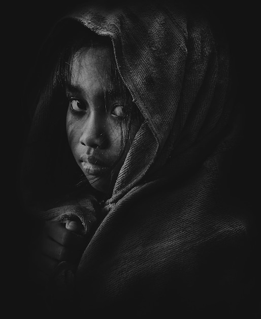 close-up portrait of girl against black background