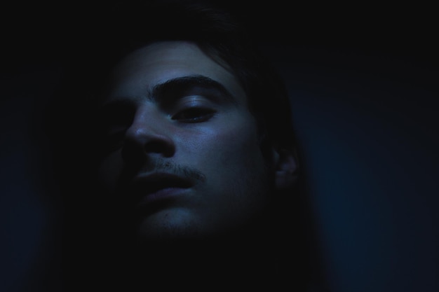 close-up portrait of man in darkroom