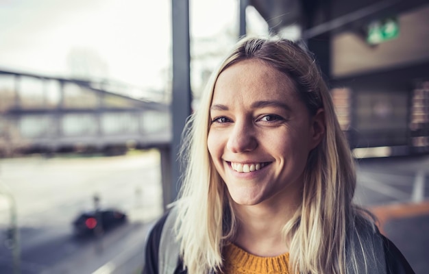 close-up portrait of smiling young woman outdoors