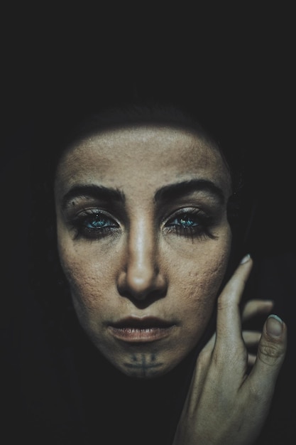 close-up portrait of spooky woman on black background