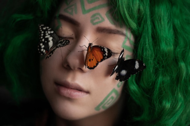 close-up portrait of young woman with butterflies